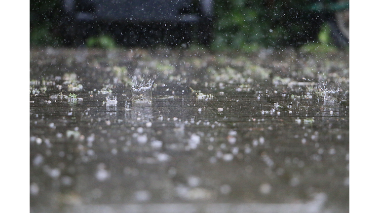 close up of falling and splashing rain on the street