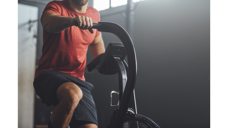 Unrecognizable  Man Doing Exercise on a Gym Stationary Bike, gym Concept