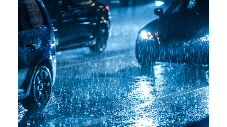 Cars driving on wet road in the rain with headlights