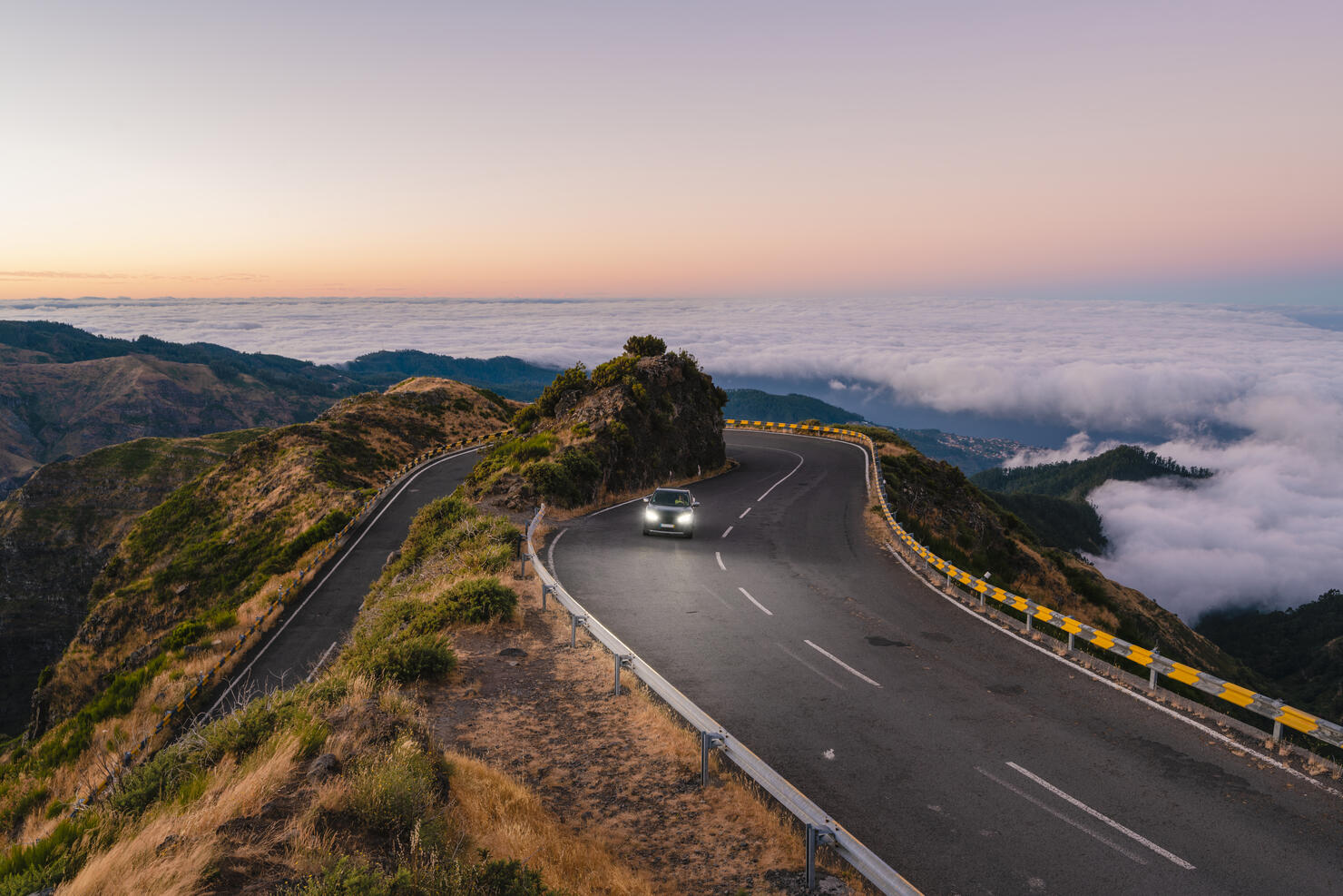 Car driving on winding mountain road, Madeira island, Portugal