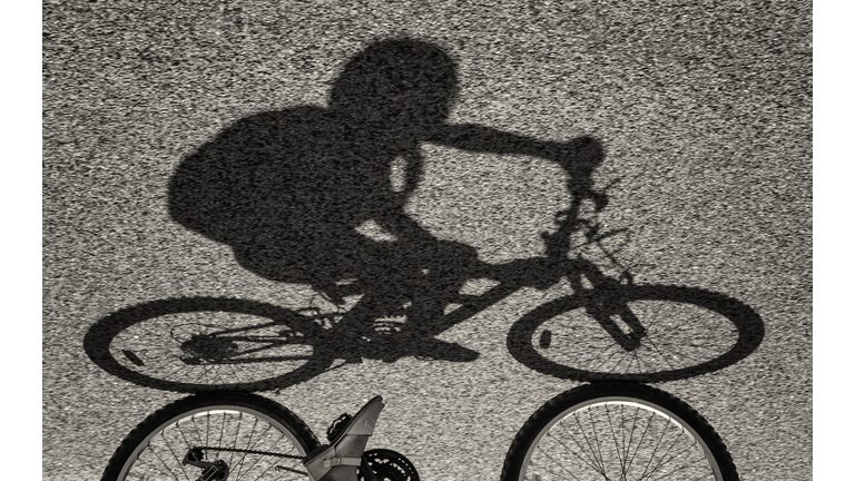 Shadow of a girl riding a bike
