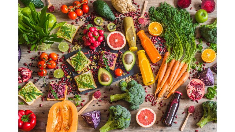 Healthy vegan food. Sandwiches and fresh vegetables on wooden background. Detox diet. Different colorful fresh juices. top view