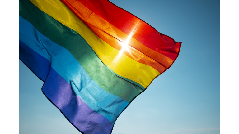 rainbow flag waving on the blue sky