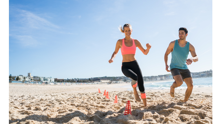 Couple exercising outdoors at the beach