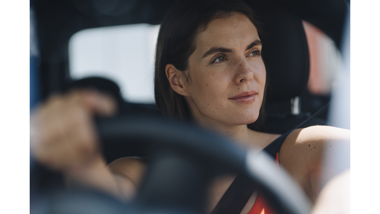 Thoughtful woman driving car