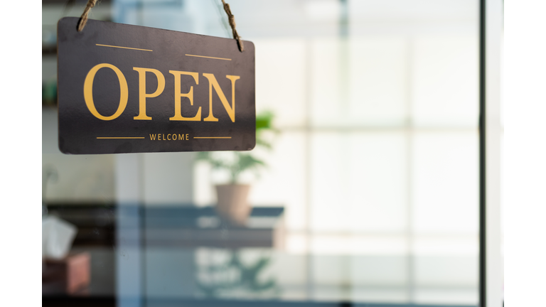 Store open sign hanging on the window