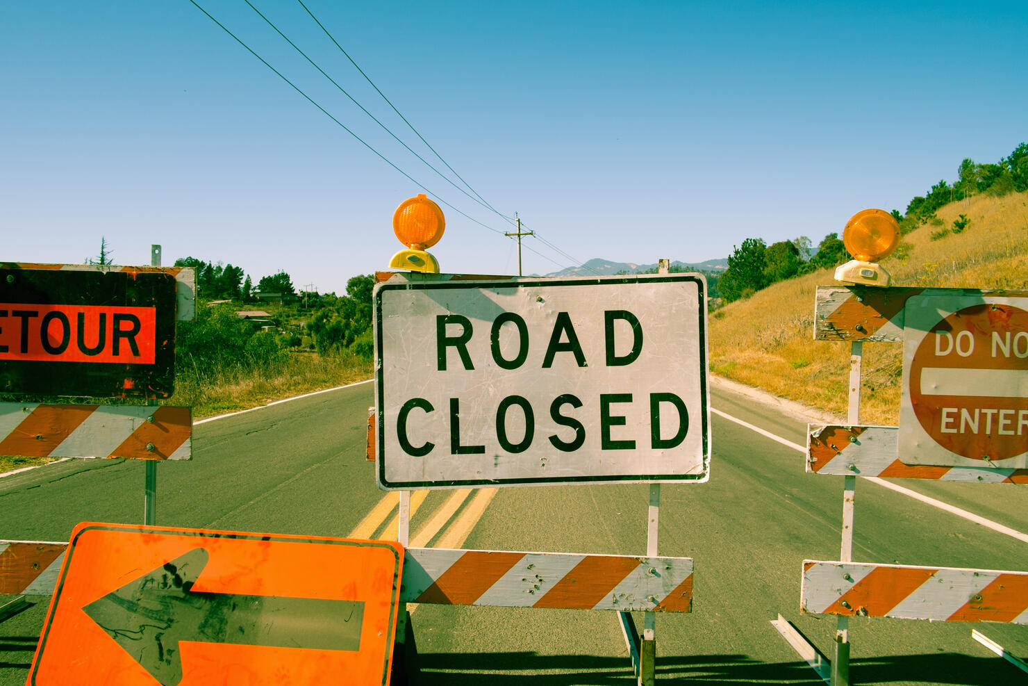 Close up row of road closed signs on highway