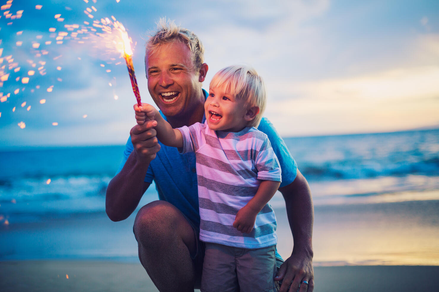 Father and son lighting fireworks