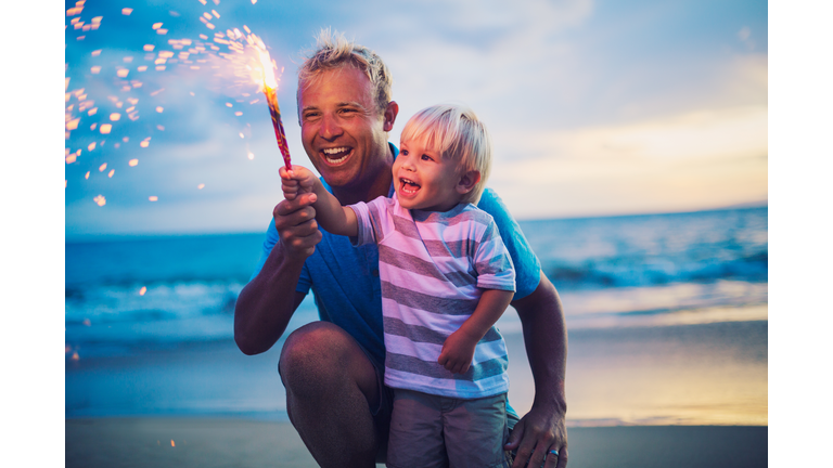 Father and son lighting fireworks