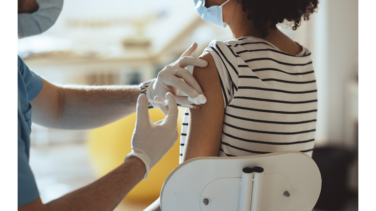 Fighting the Pandemic: Nurse Injecting a Patient With a Vaccine in Her Arm