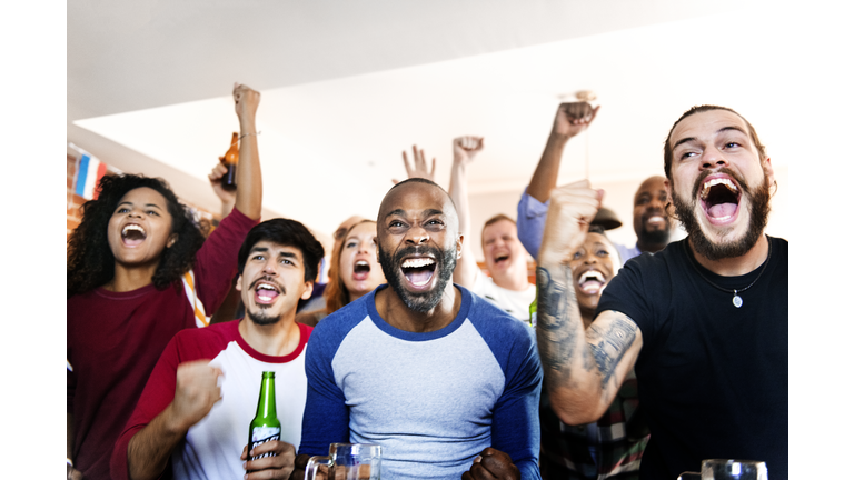 Friends cheering sport at bar together