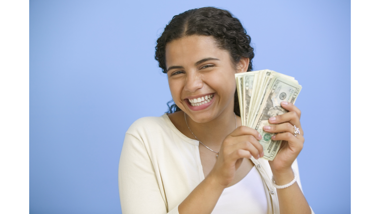 Portrait of teenage girl holding money