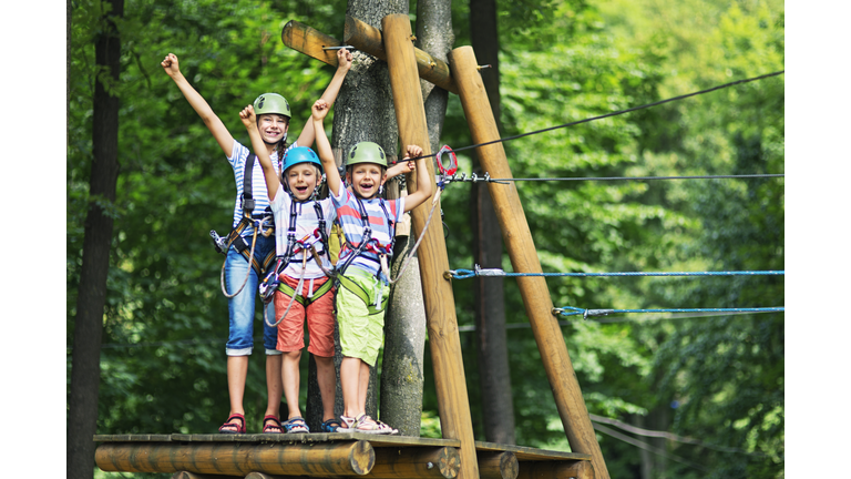 Kids having fun in ropes course adventure park