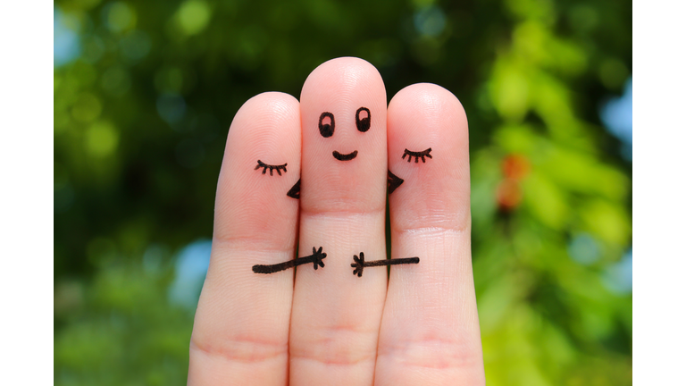 Finger art. Two women kissing a man.