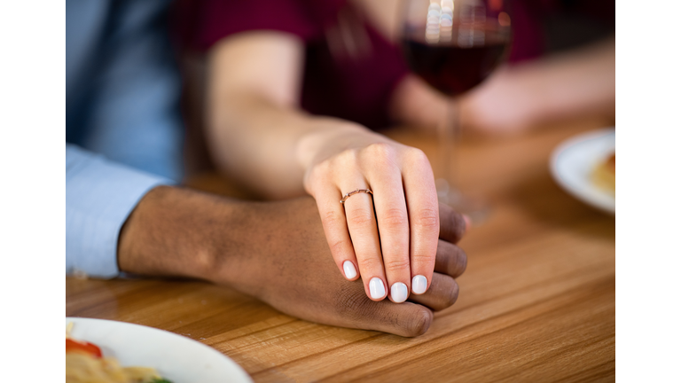 She Said Yes. Female Hand With Engagement Ring Holding Black Boyfriend's Hand