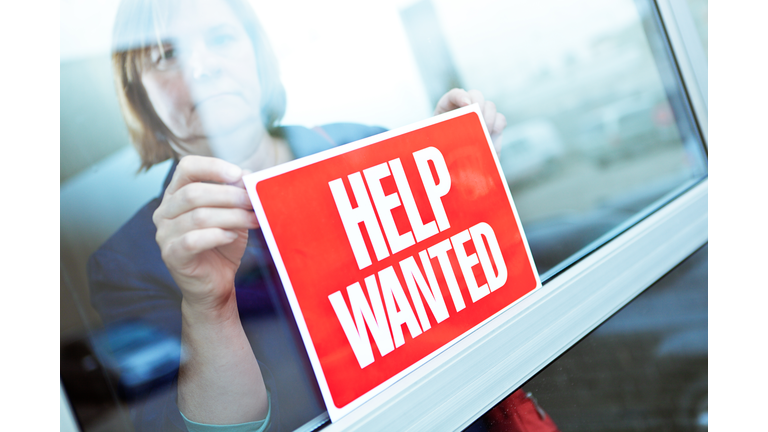 Help Wanted Sign on Retail Display Window for Employment Job Available