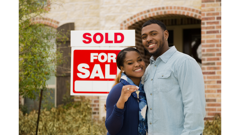 Real Estate: African descent couple buys first home. House key.