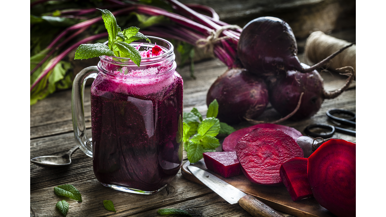 Healthy drink: beet juice on rustic wooden table