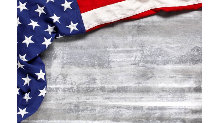 US American flag on worn white wooden background. For USA Memorial day, Veteran's day, Labor day, or 4th of July celebration. With blank space for text.