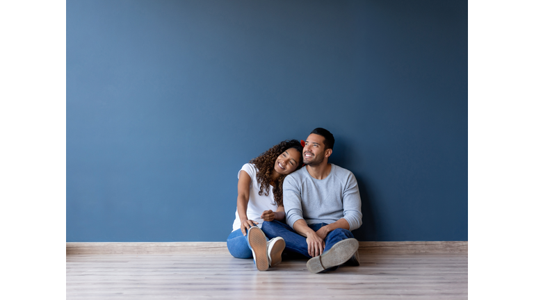 Happy couple smiling in their new home