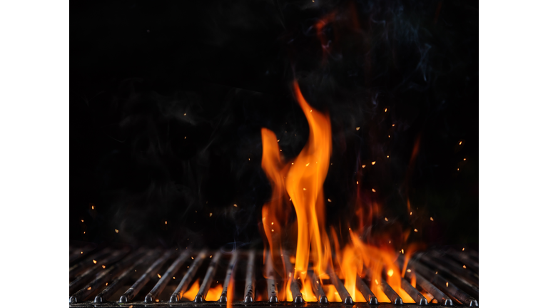 Empty flaming charcoal grill with open fire