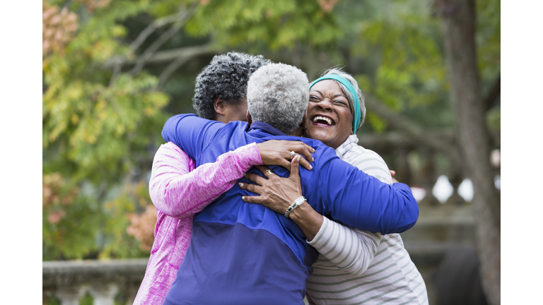 Three seniors hugging