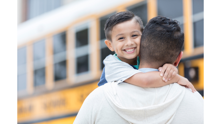 Schoolboy greets father after first day