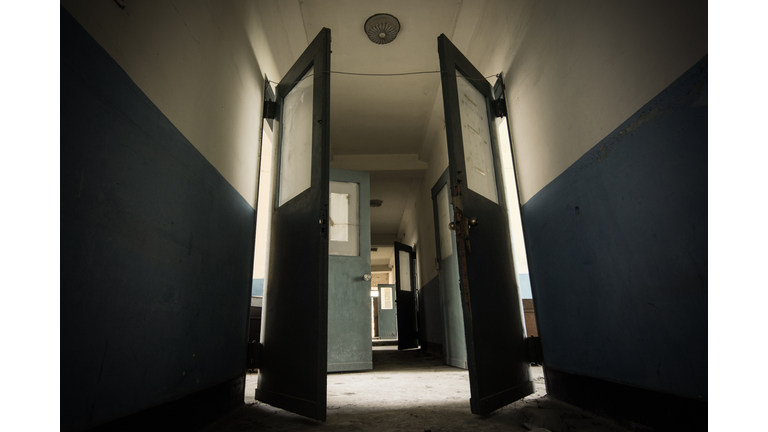 Dark hallway in a scary and possibly haunted abandoned sanatorium from the 1930s