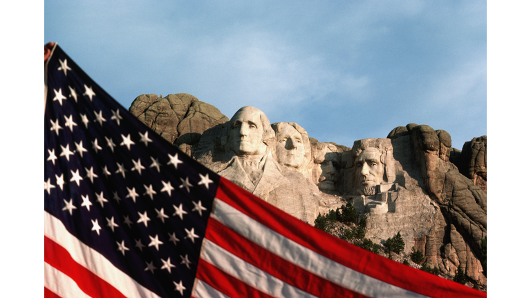 American Flag With Mount Rushmore Behind