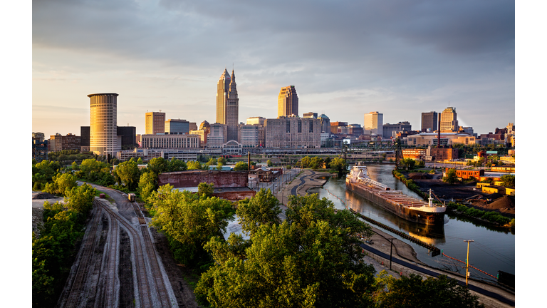 Dusk skyline of downtown Cleveland Ohio with freighter on the Cuyahoga River