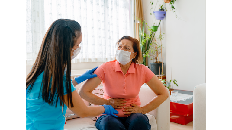 Abdominal pain patient woman having medical exam with doctor on illness from stomach cancer, irritable bowel syndrome, pelvic discomfort, Indigestion, Diarrhea, GERD (gastro-esophageal reflux disease)