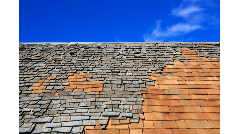 Roof construction site. Removal of old roof, replacement with new shingles, equipment and repair.