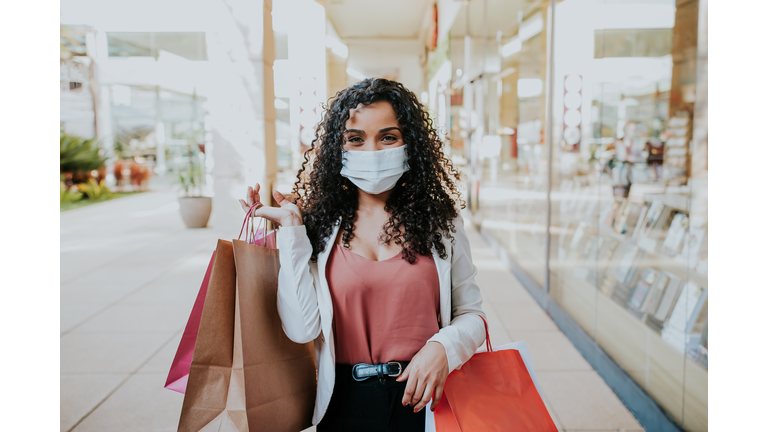 Woman walking shopping and Smiling behind the mask