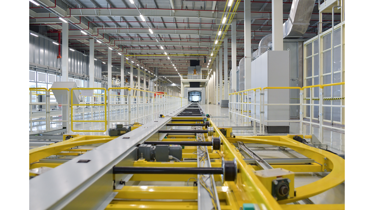 Conveyor rollers transport system of automotive production line, part of industrial equipment vehicles of manufacturing in the factory.