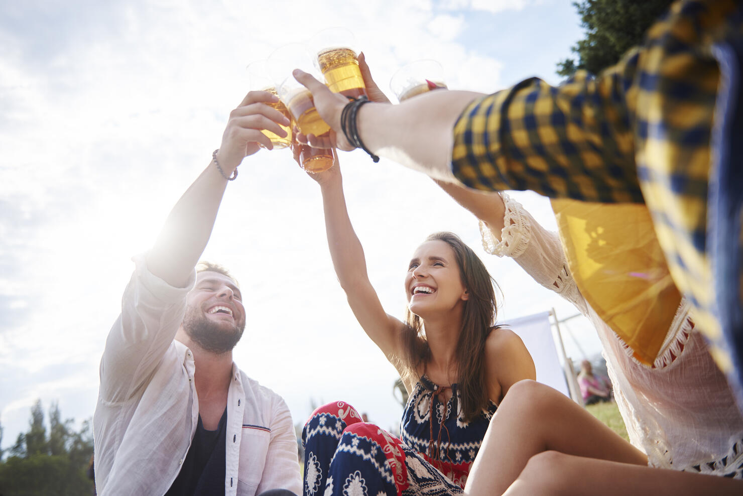 Friends sitting and enjoying music festival