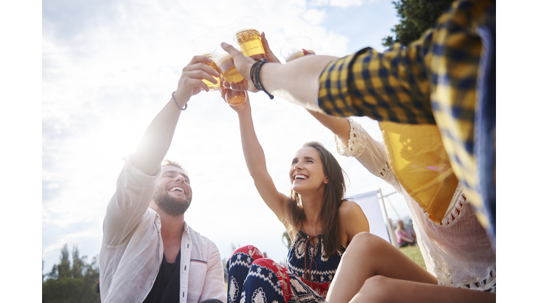 Friends sitting and enjoying music festival