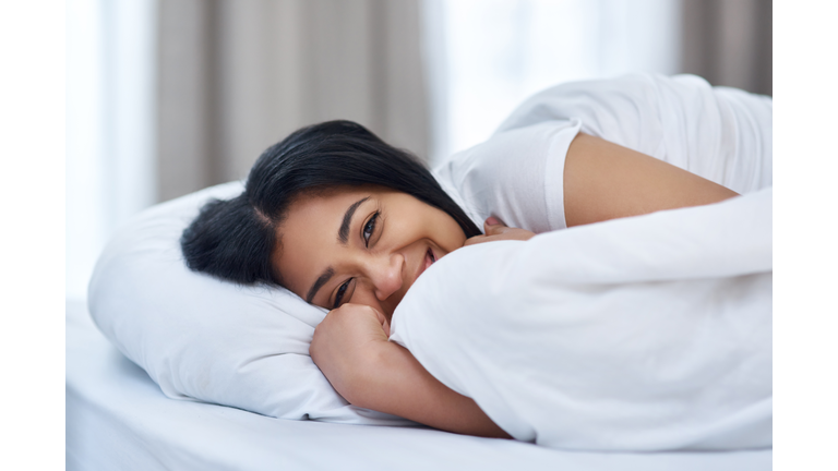 Shot of a young woman in bed at home