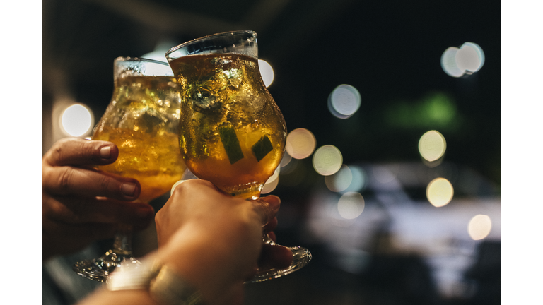 In Fort de France, a couple celebrating with each a Martinican rum cocktail in their hand.