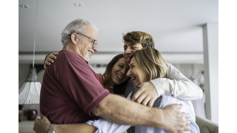 Grandchild and grandparents embracing