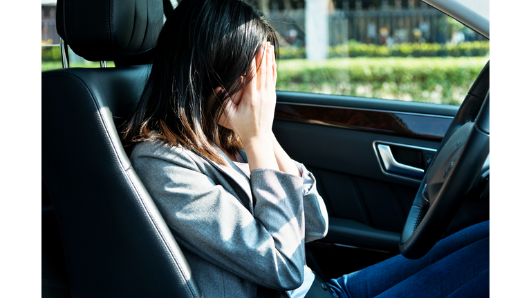 Sad businesswoman driver sitting in car