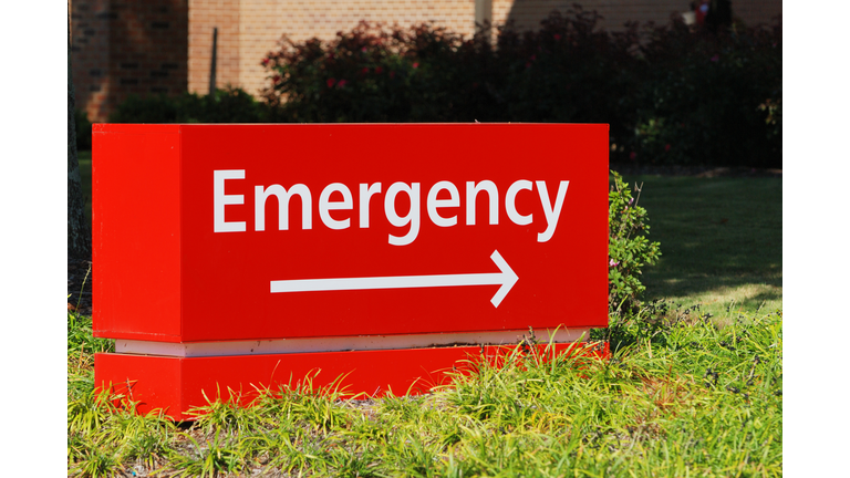 Red emergency room sign with directional arrow