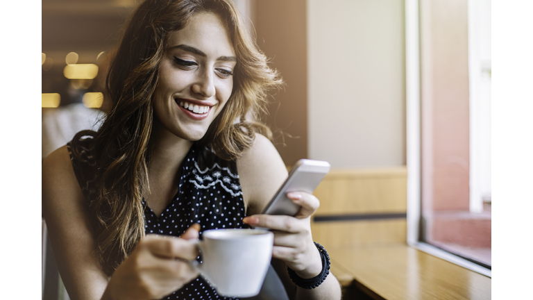 Checking messages and having coffee