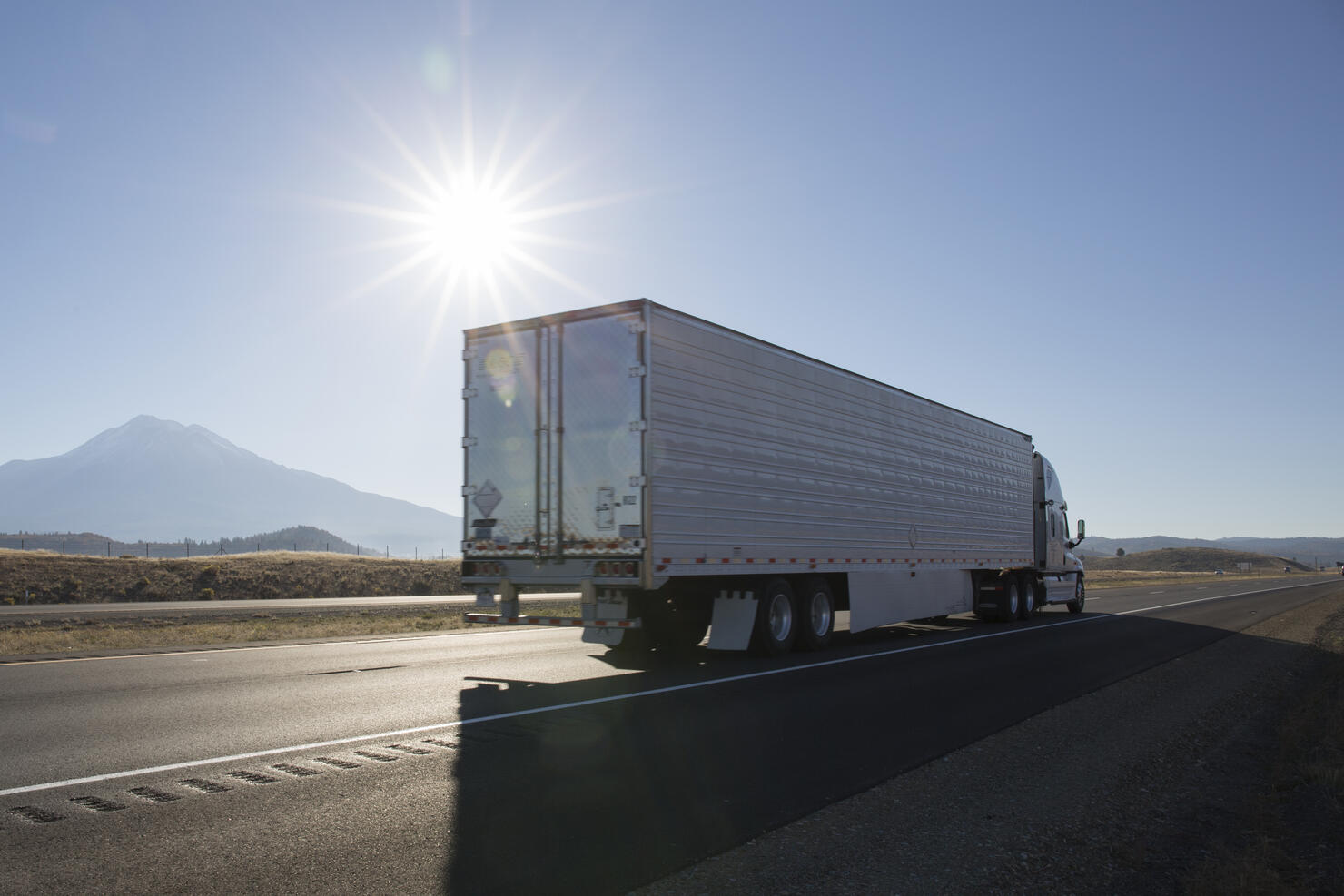 Semi-trailer truck motors along empty highway