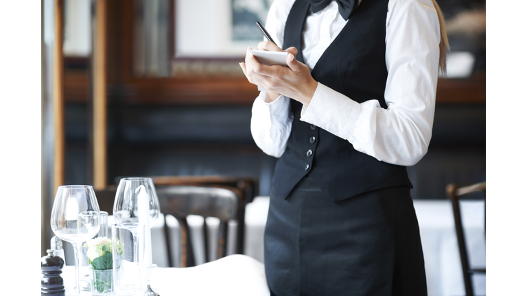 Denmark, Aarhus, Young waitress taking order