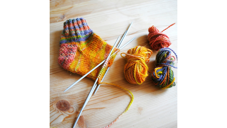 Ball Of Wool, Sock With Knitting Needles On Wooden Table