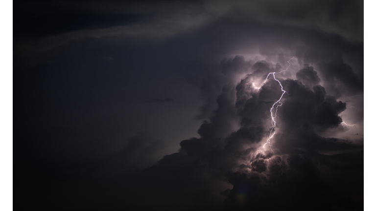 Low Angle View Of Lightning Against Cloudy Sky At Dusk