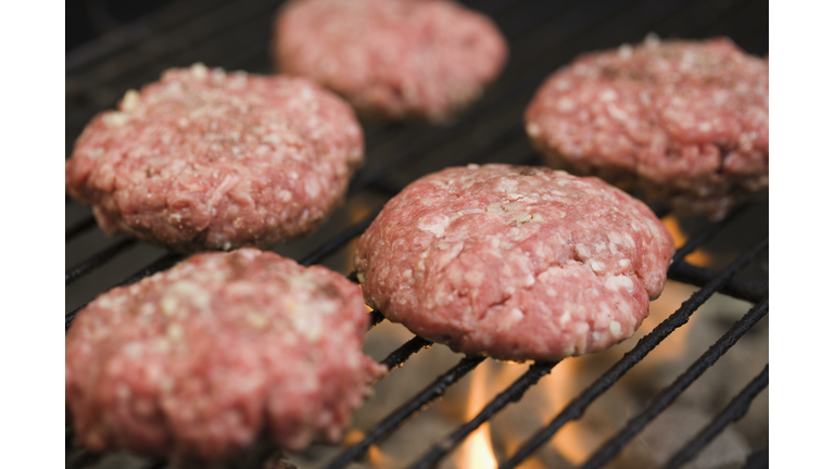 Hamburger patties cooking on grill