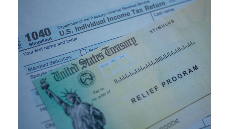 Form 1040 U.S. Individual Income tax return next to the Stimulus Check Relief program. Close up view.