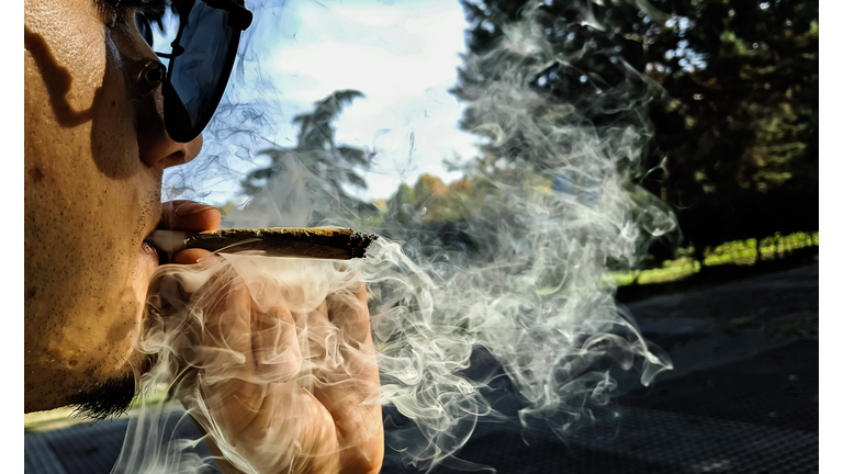 Close-Up Of Man Smoking Marijuana Joint