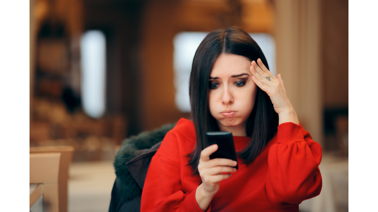 Stressed Woman Reading Text Message on Smartphone